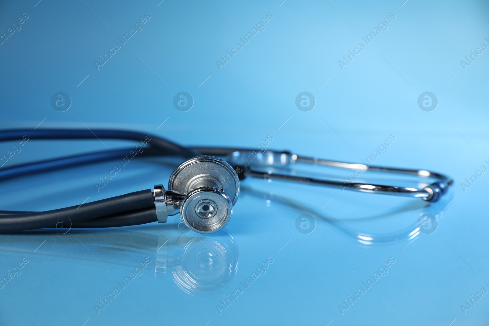Stethoscope on light blue background, closeup. Medical tool Photo of Stethoscope on light blue background, closeup. Medical tool