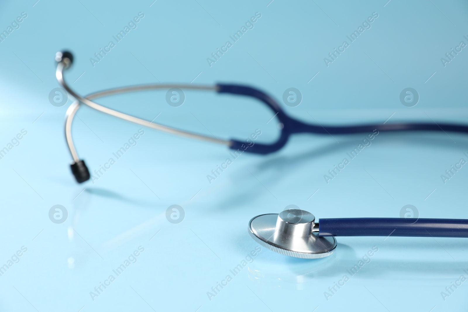 Stethoscope on light blue background, closeup. Medical tool Photo of Stethoscope on light blue background, closeup. Medical tool