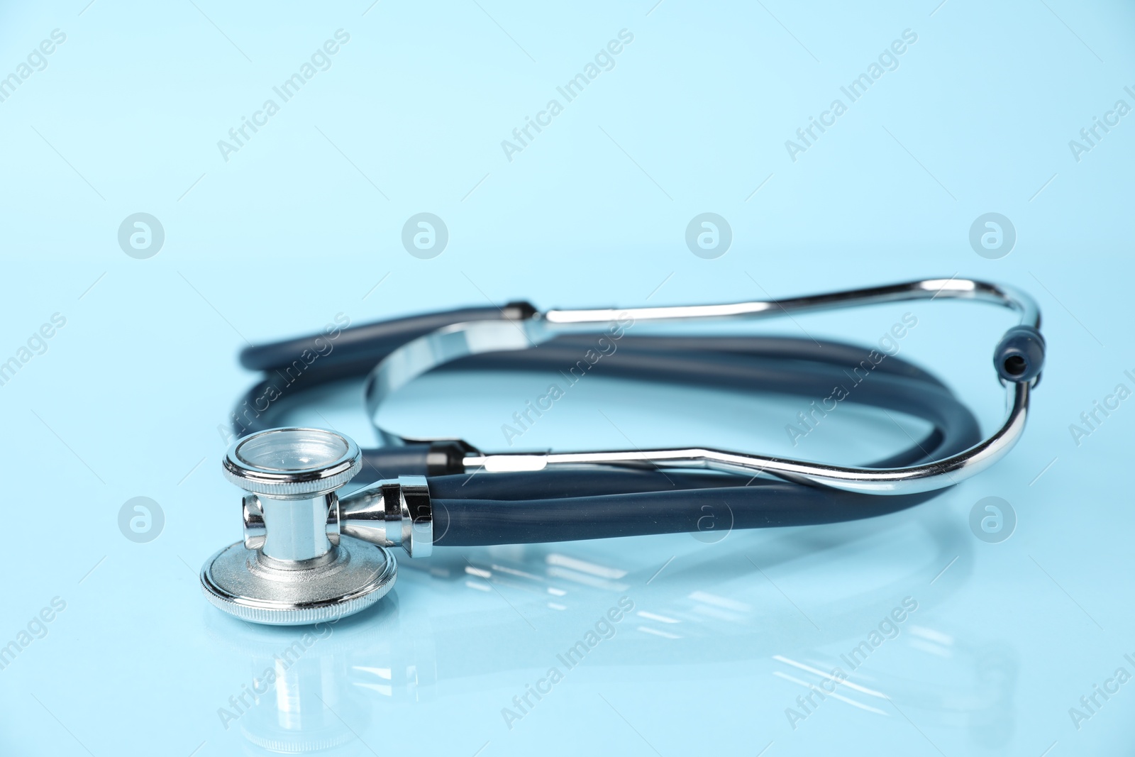 Stethoscope on light blue background, closeup. Medical tool Photo of Stethoscope on light blue background, closeup. Medical tool