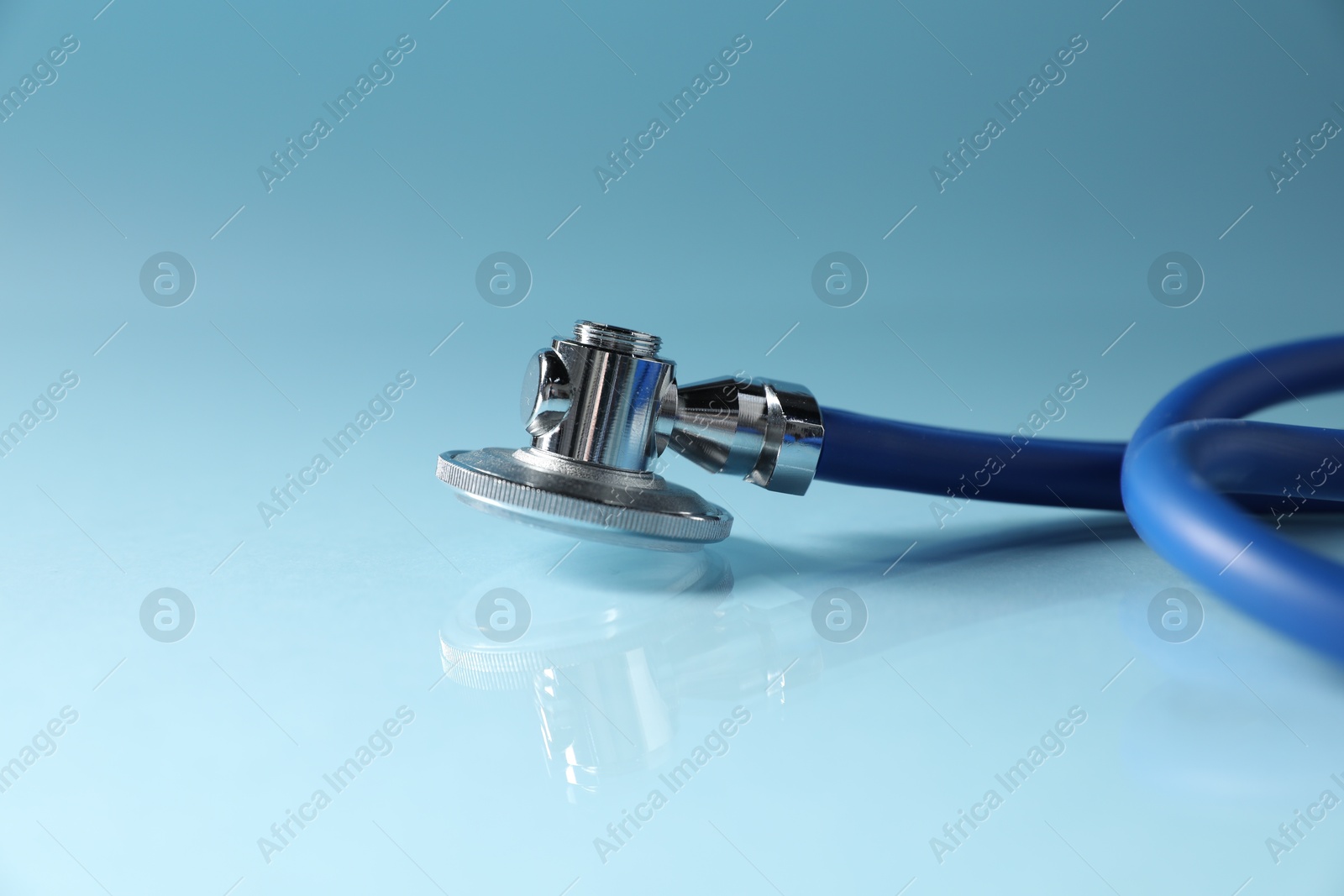 Stethoscope on light blue background, closeup. Space for text Photo of Stethoscope on light blue background, closeup. Space for text