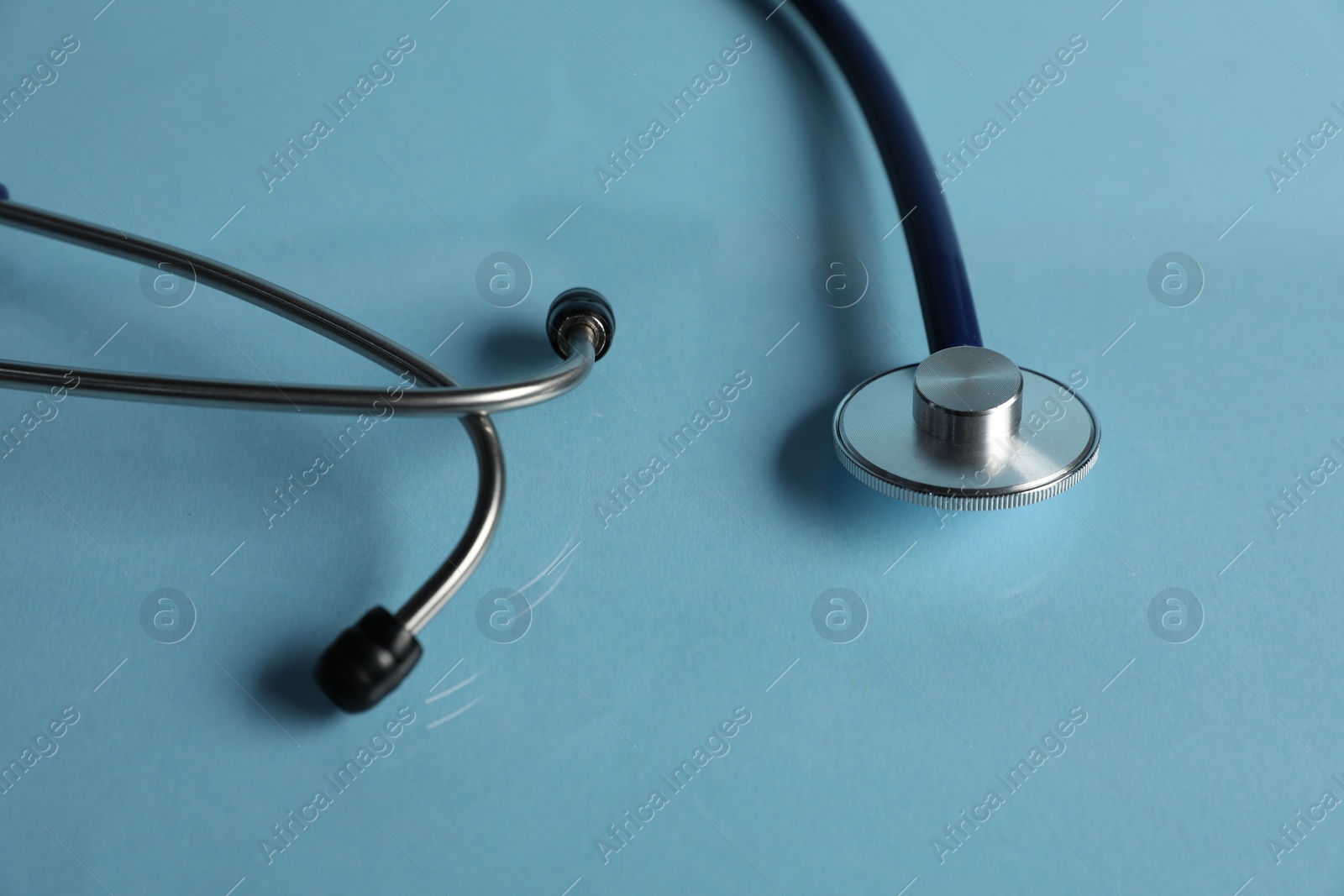 Stethoscope on light blue background, closeup. Medical tool Photo of Stethoscope on light blue background, closeup. Medical tool