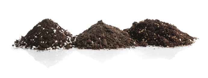 Photo of Piles of fresh soil isolated on white