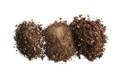 Photo of Piles of fresh soil isolated on white, top view