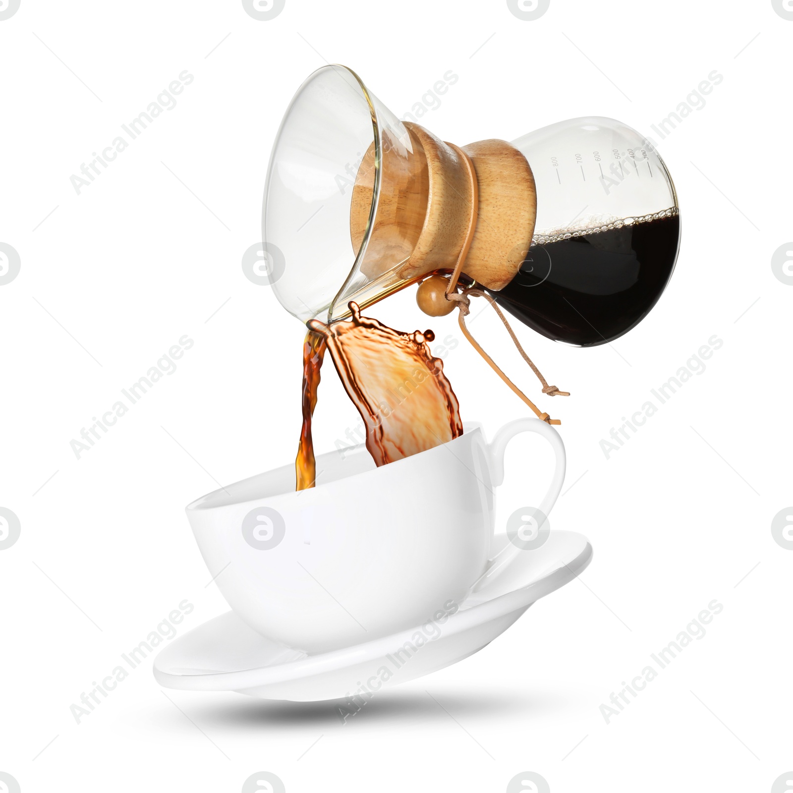 Image of Pouring freshly brewed coffee from glass coffeemaker into cup on white background