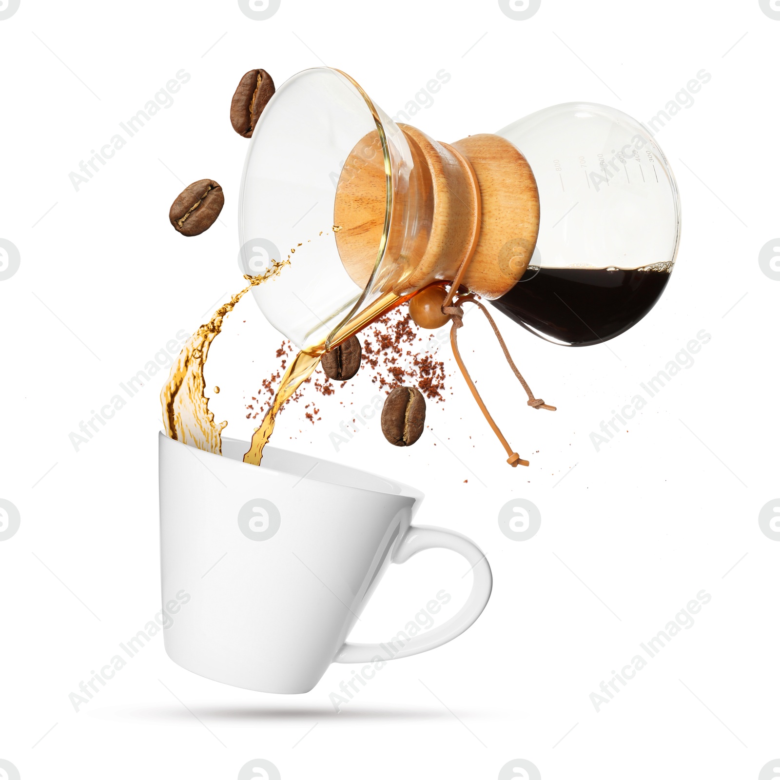 Image of Pouring freshly brewed coffee from glass coffeemaker into cup on white background