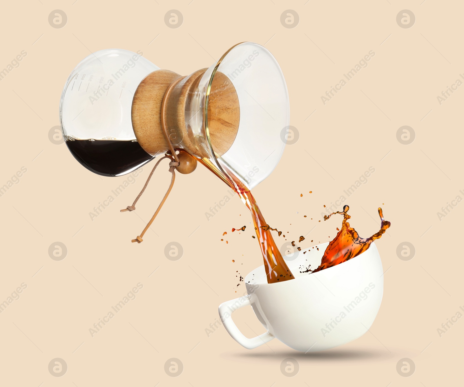 Image of Pouring freshly brewed coffee from glass coffeemaker into cup on beige background