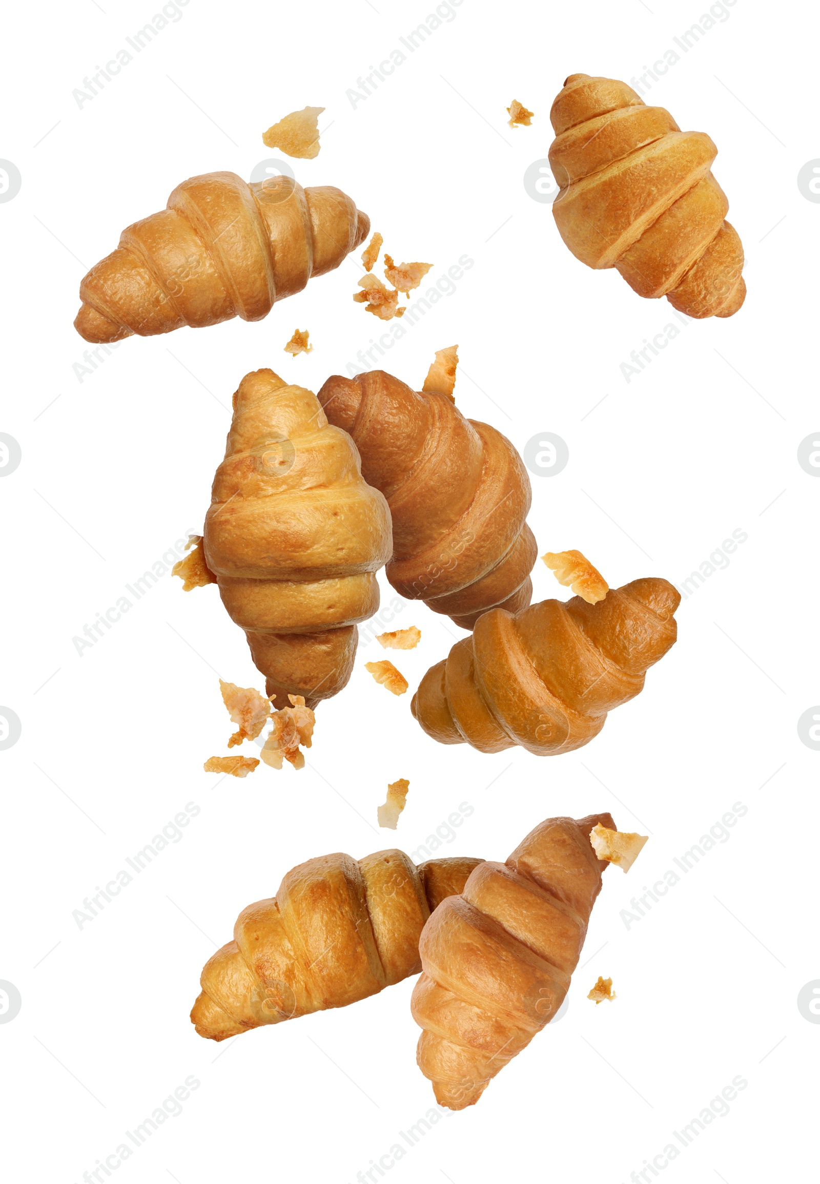 Image of Delicious croissants and crumbs in air on white background. Puff pastry