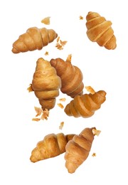 Image of Delicious croissants and crumbs in air on white background. Puff pastry