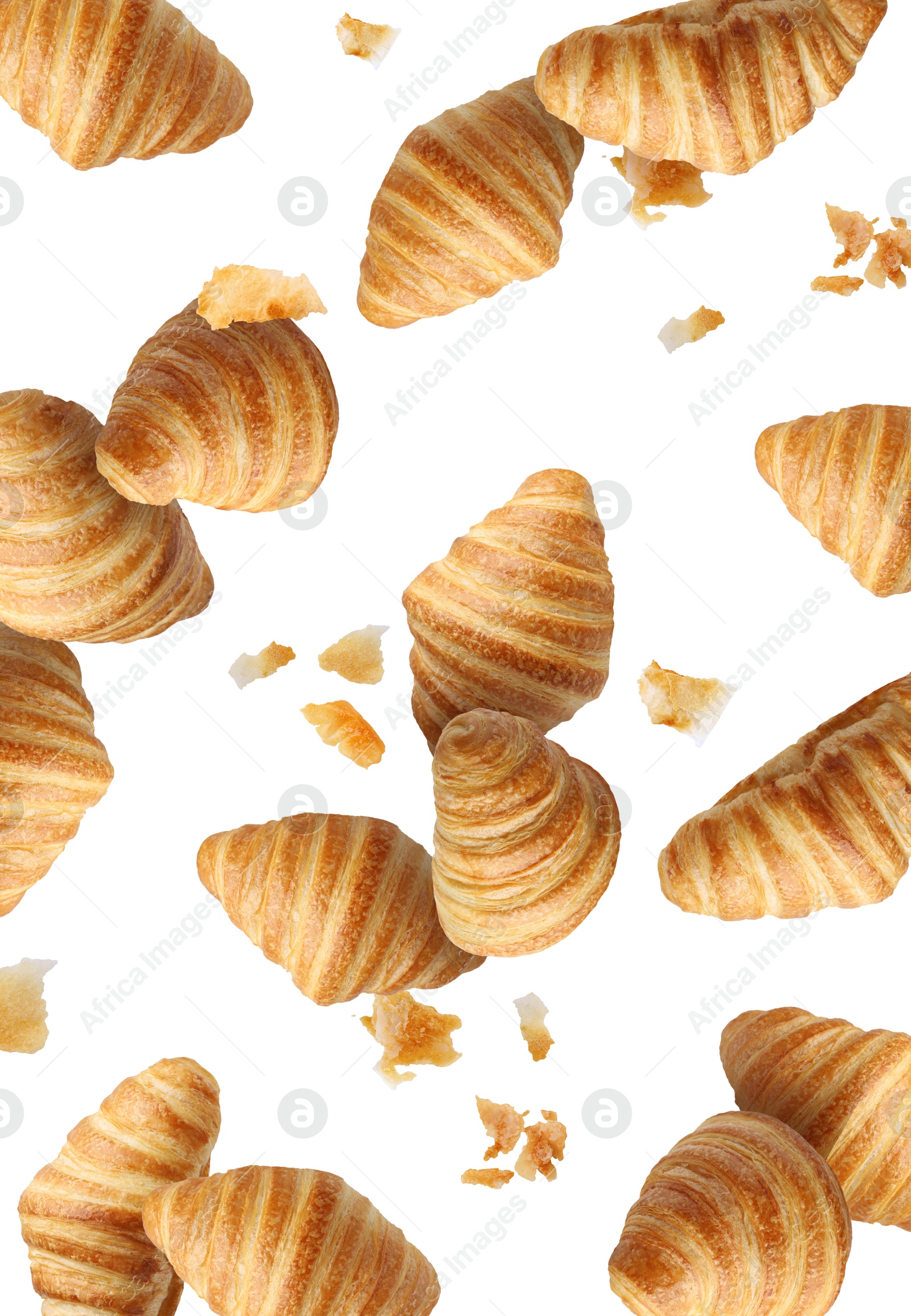 Image of Delicious croissants and crumbs in air on white background. Puff pastry