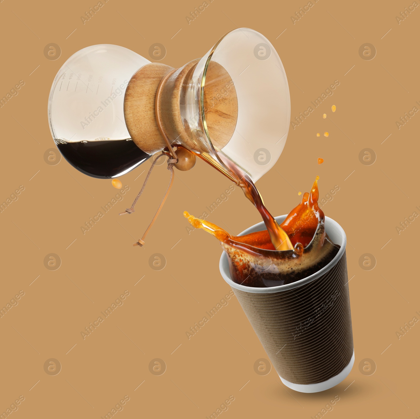 Image of Pouring freshly brewed coffee from glass coffeemaker into take-away paper cup on light brown background