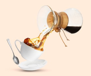 Image of Pouring freshly brewed coffee from glass coffeemaker into cup on pink beige background