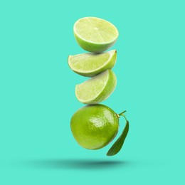 Image of Fresh juicy limes falling on turquoise background