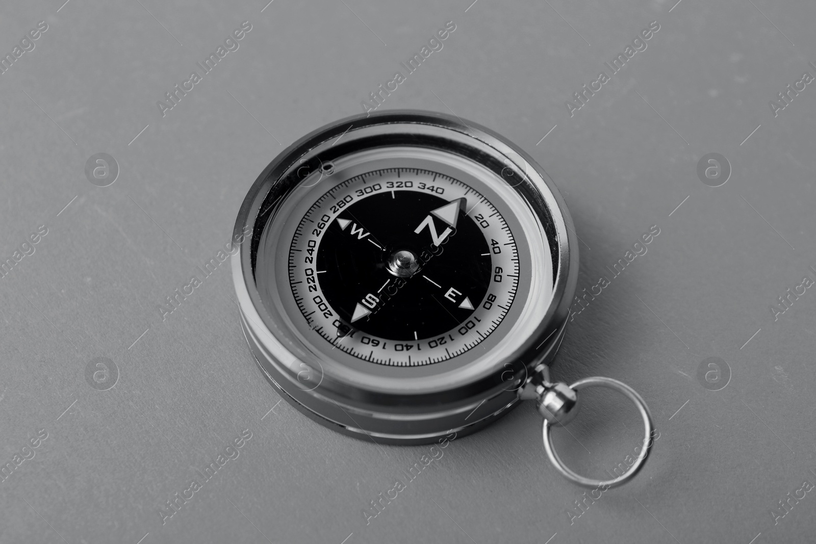 Image of Compass on table, closeup. Toned in black-and-white