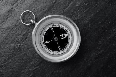 Image of Compass on textured table, top view. Toned in black-and-white