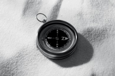 Image of Compass on sand, closeup. Toned in black-and-white