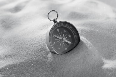 Image of Compass in sand, closeup. Toned in black-and-white