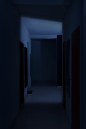 Image of Dark empty corridor in hospital or office building at night