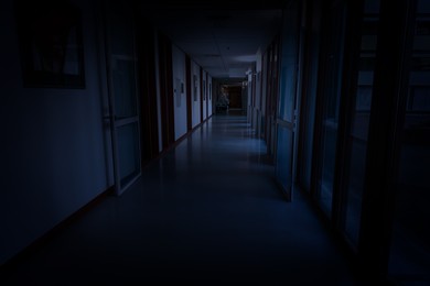 Image of Dark empty corridor in hospital building at night