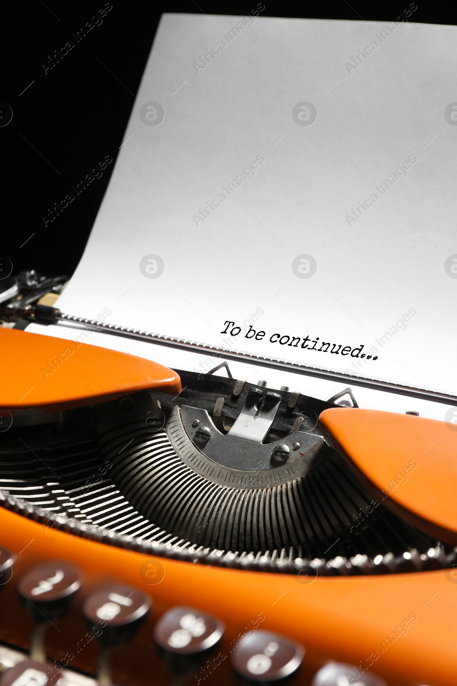 Image of Typewriter with sheet of paper, closeup. Typed text To Be Continued