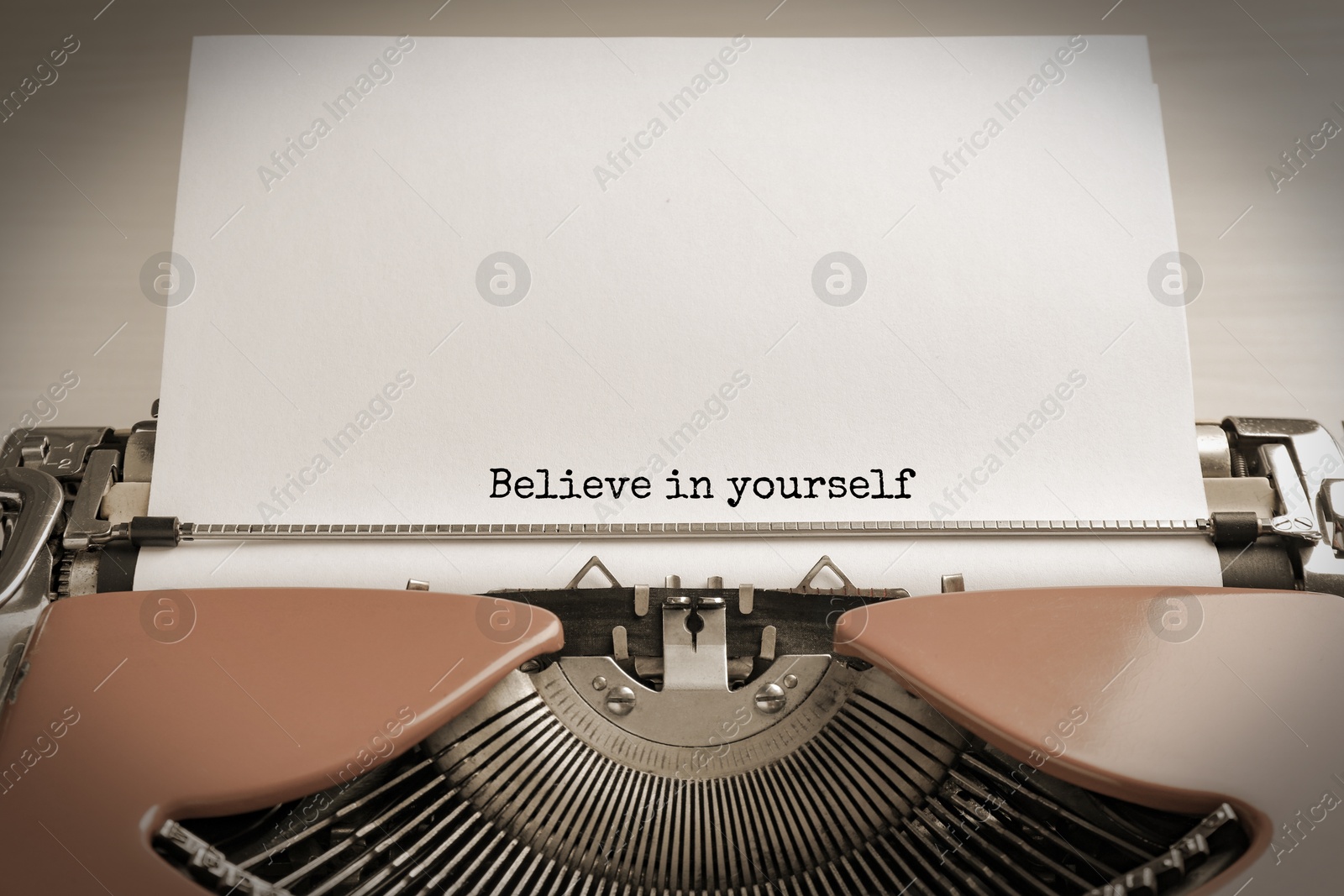 Image of Typewriter with sheet of paper, closeup. Typed text Believe In Yourself