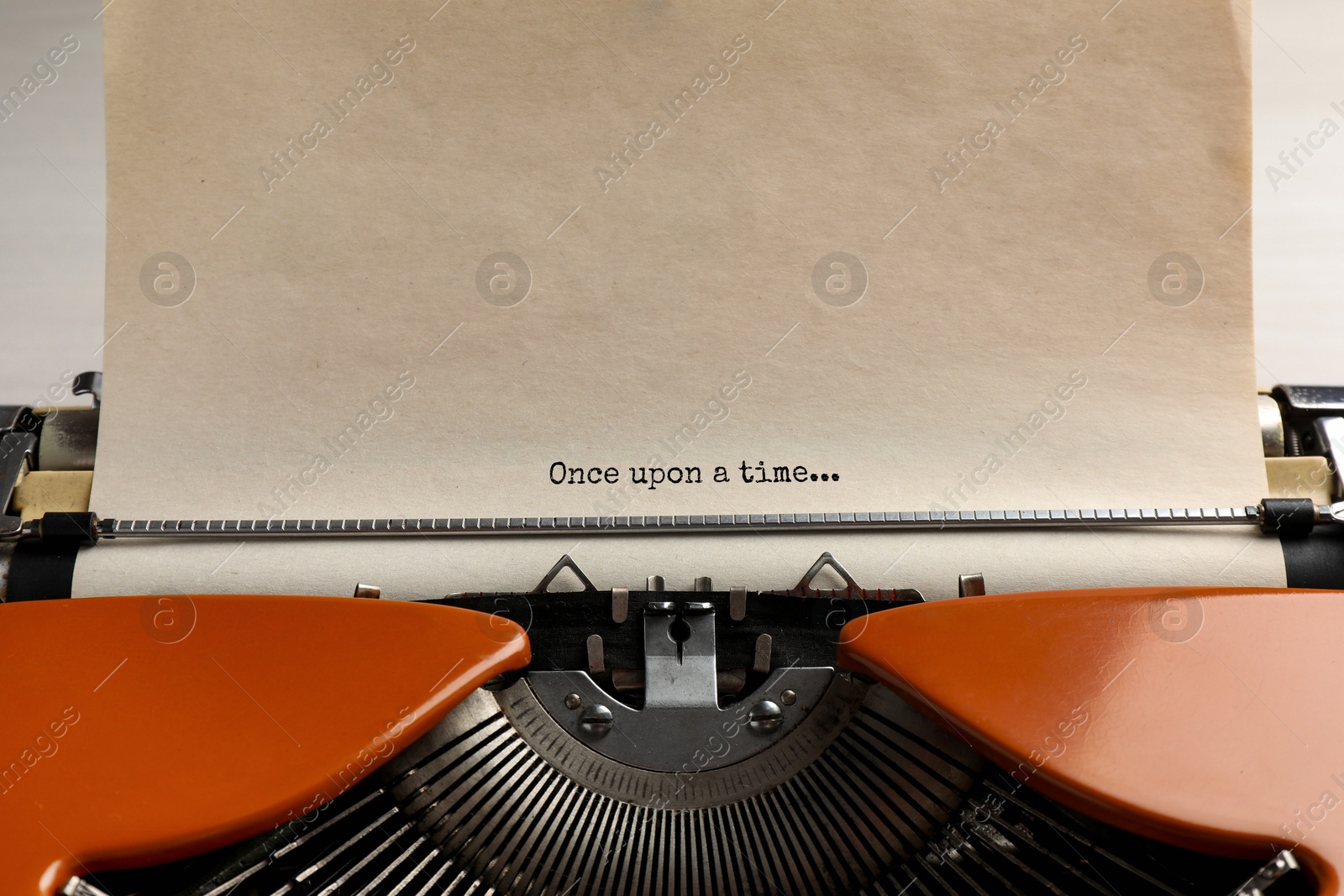 Image of Typewriter with sheet of paper, closeup. Typed text Once Upon A Time