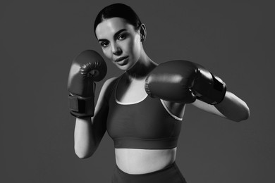 Image of Beautiful woman wearing boxing gloves, black-and-white toning