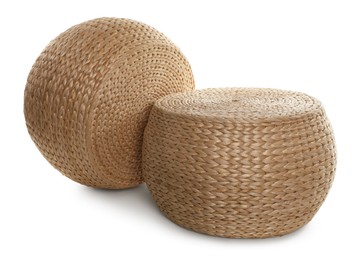 Photo of Two stylish wicker poufs on white background