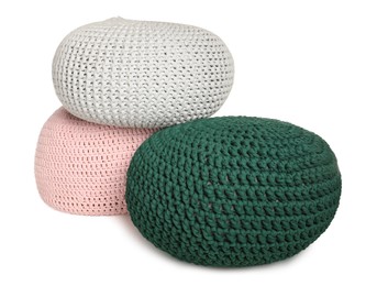 Photo of Stylish colorful knitted poufs on white background