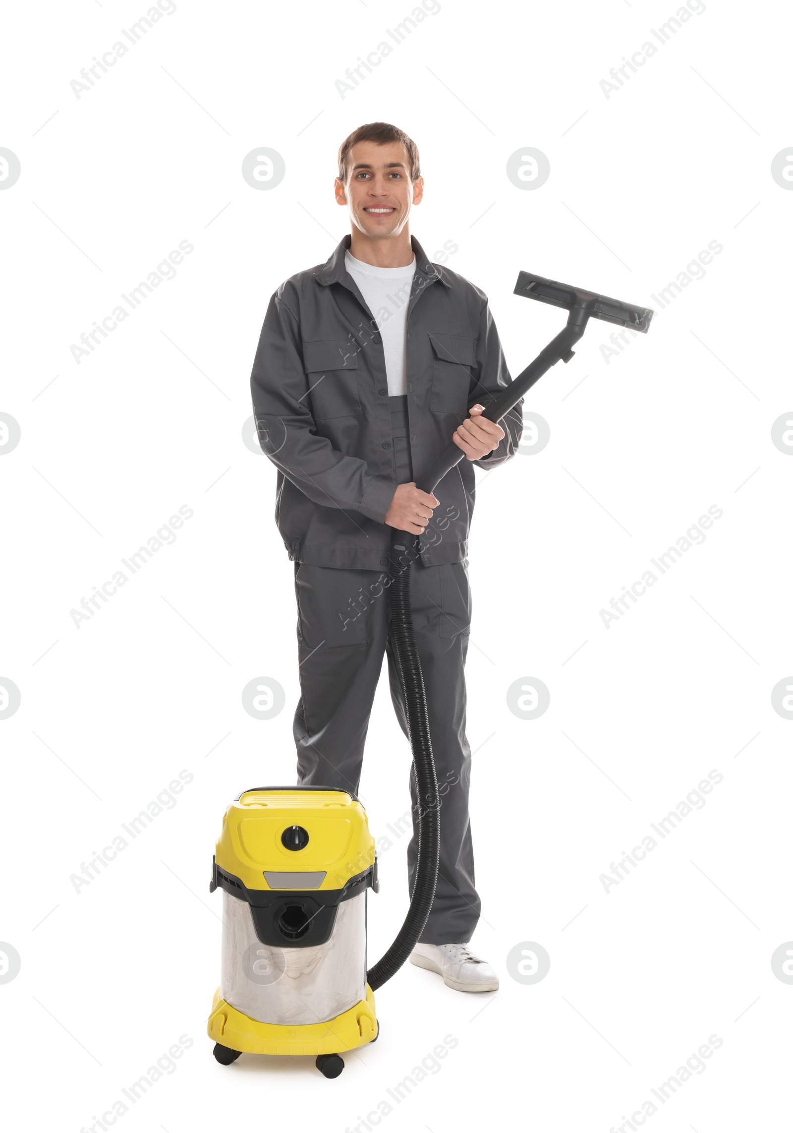 Photo of Smiling cleaning service worker with vacuum cleaner on white background