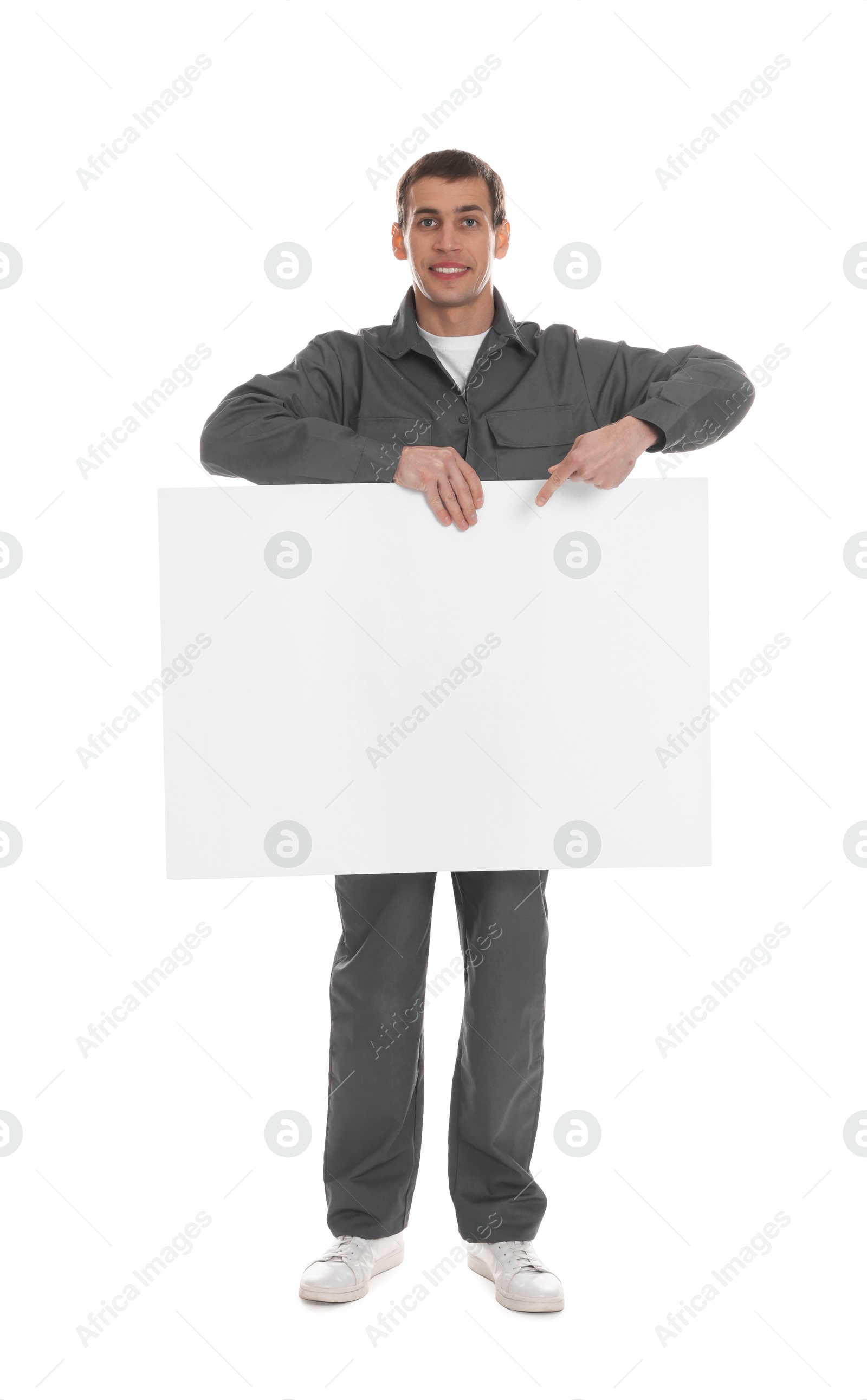 Photo of Smiling cleaning service worker with sheet of paper on white background. Space for text