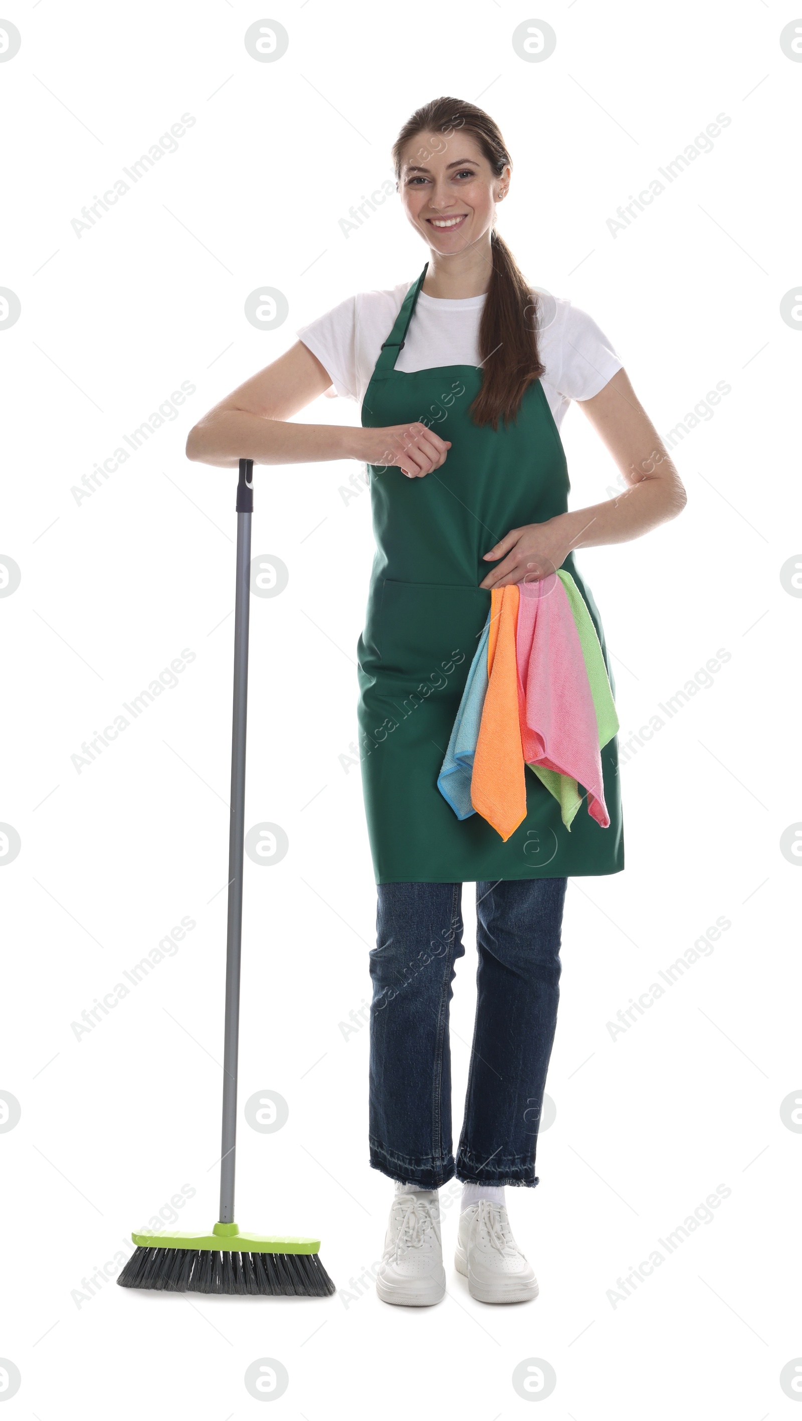 Photo of Smiling cleaning service worker with broom and rags on white background