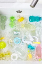 Photo of Washing feeding bottles in sink, top view