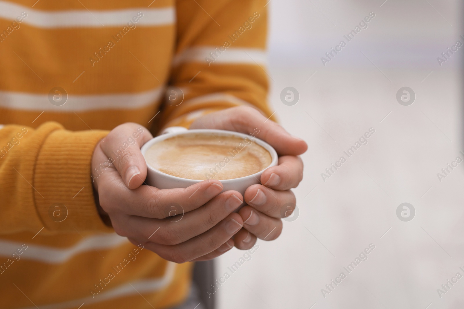 Photo of Coffee break. Woman with cup of hot drink indoors, closeup