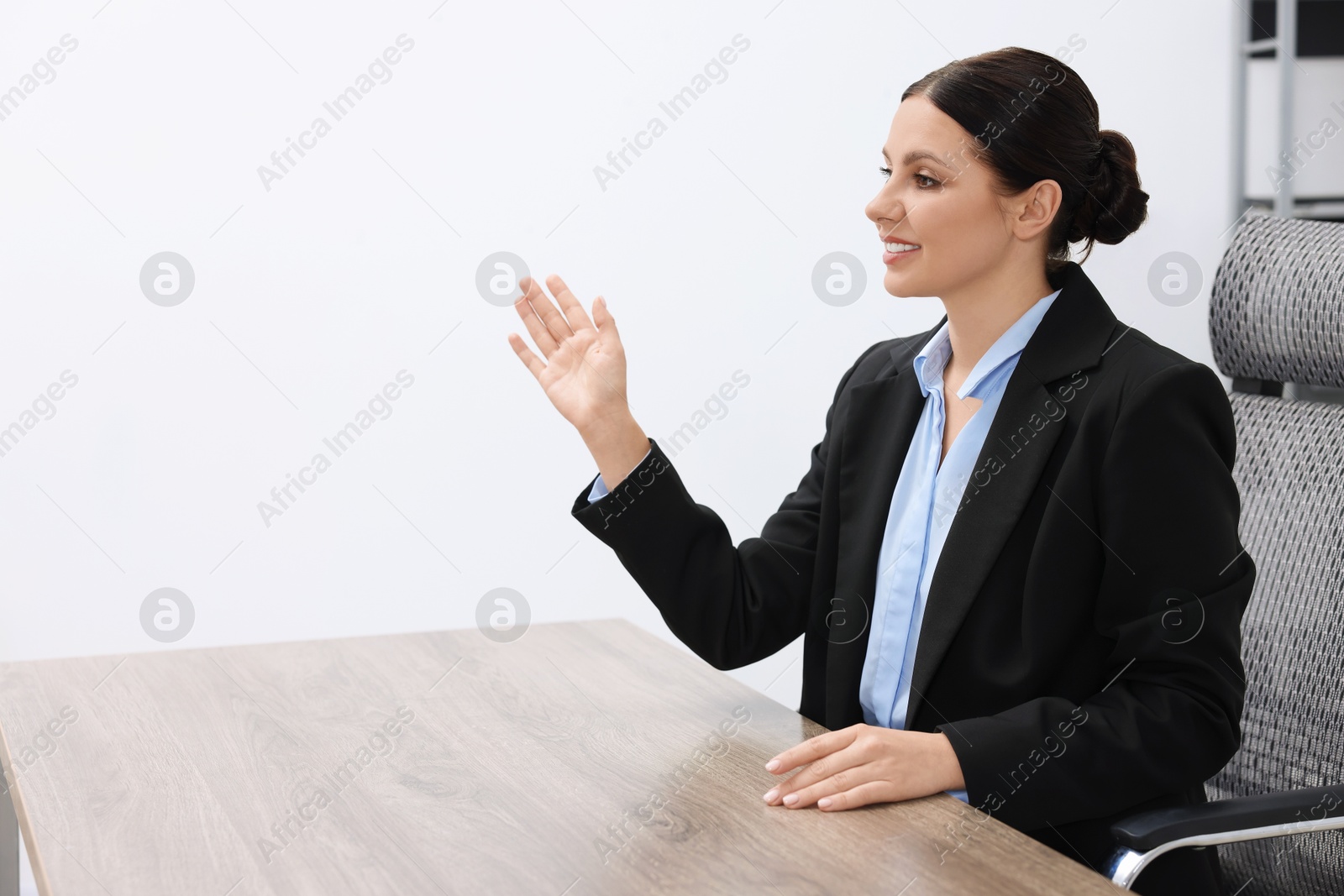 Photo of Beautiful woman looking at something in office, space for text