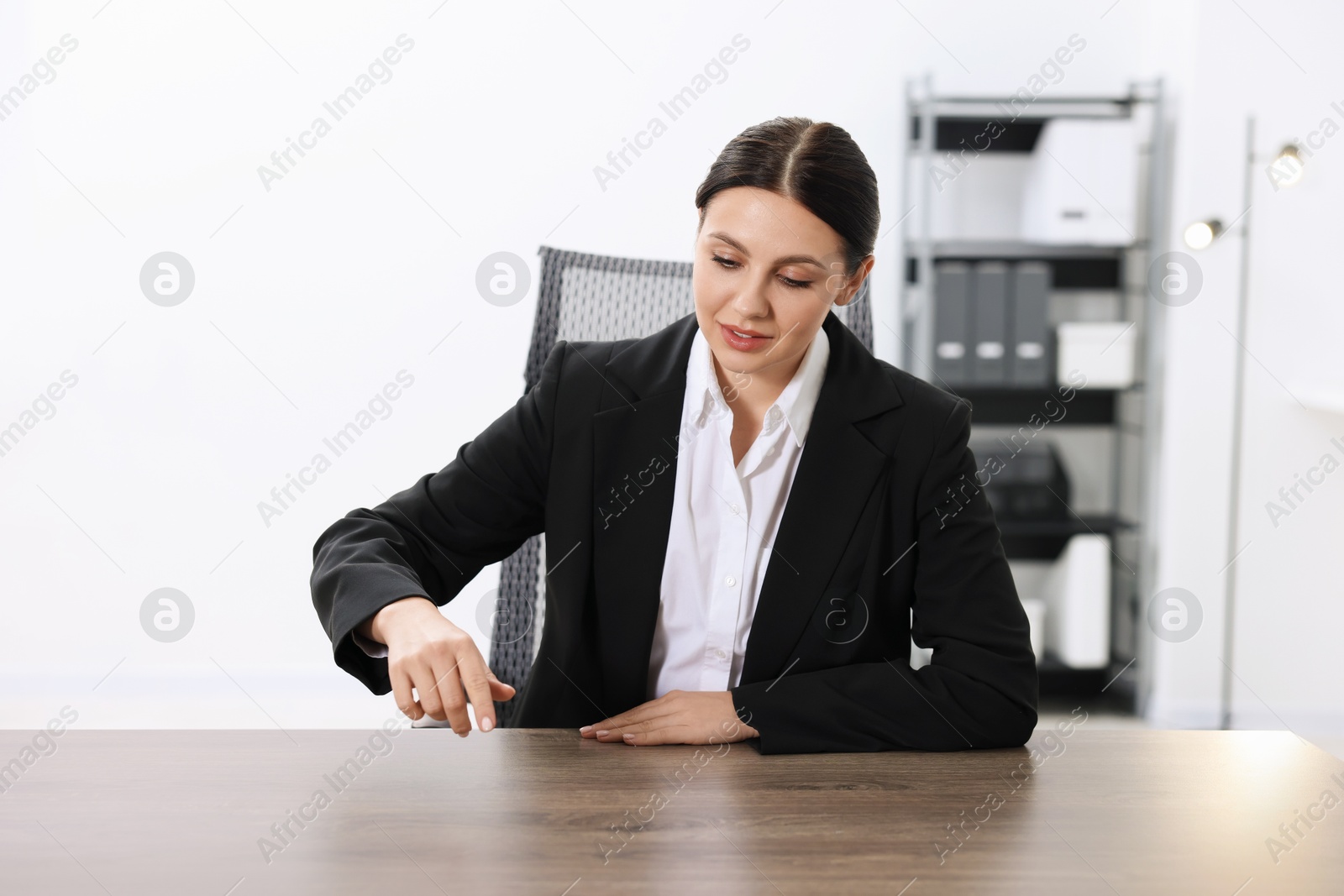 Photo of Beautiful woman pointing at something in office