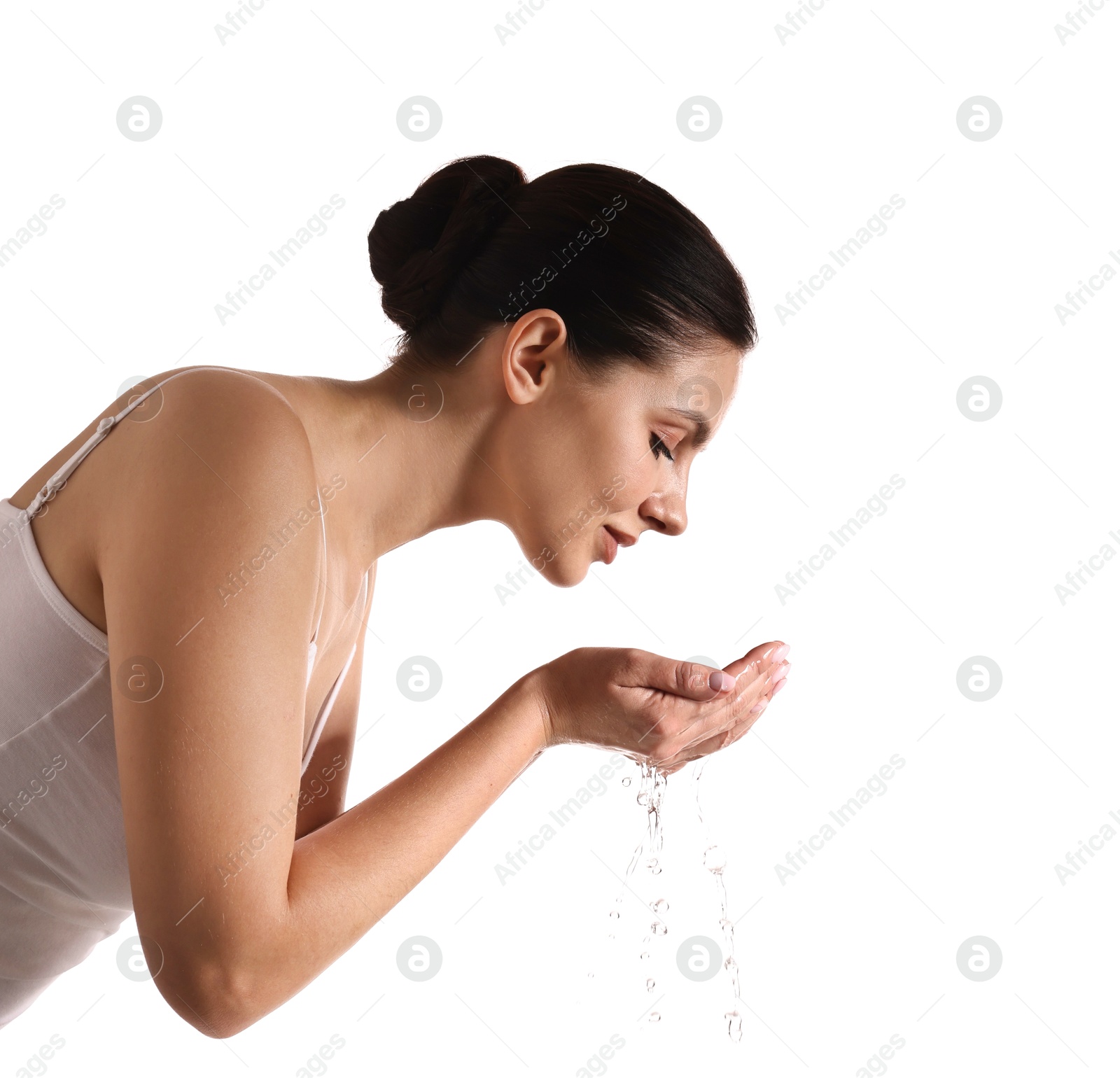 Photo of Attractive woman washing her face on white background