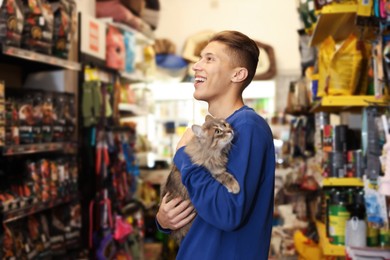 Man with his cute cat in pet shop