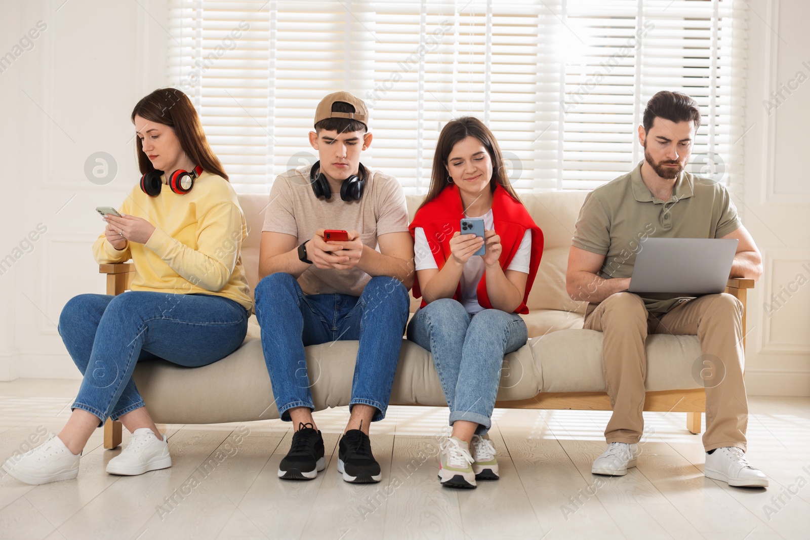 Photo of Internet addiction. Group of people with gadgets on sofa indoors