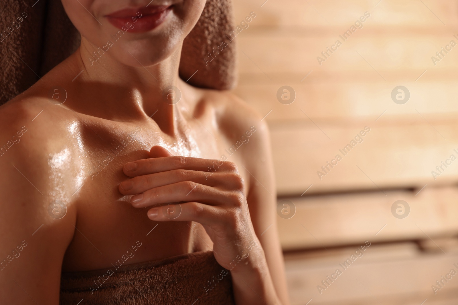 Photo of Beautiful woman in hot sauna, closeup. Space for text