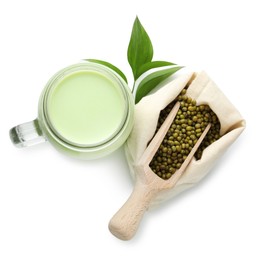 Photo of Fresh mung bean juice in mason jar, scoop, seeds and green leaves isolated on white, top view