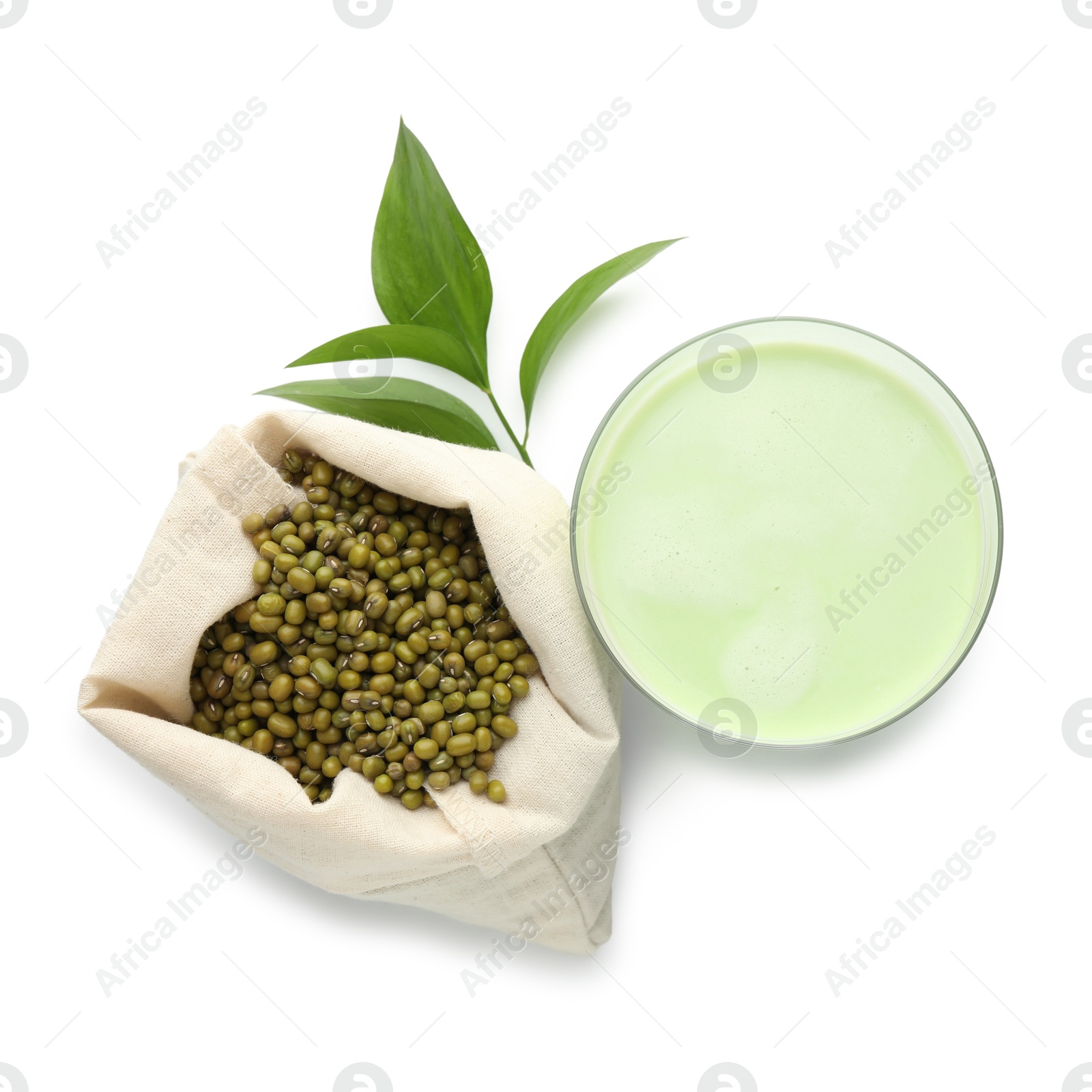Fresh mung bean juice in glass, seeds and green leaves isolated on white, top view Photo of Fresh mung bean juice in glass, seeds and green leaves isolated on white, top view