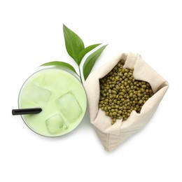 Photo of Fresh mung bean juice in glass, seeds and green leaves isolated on white, top view