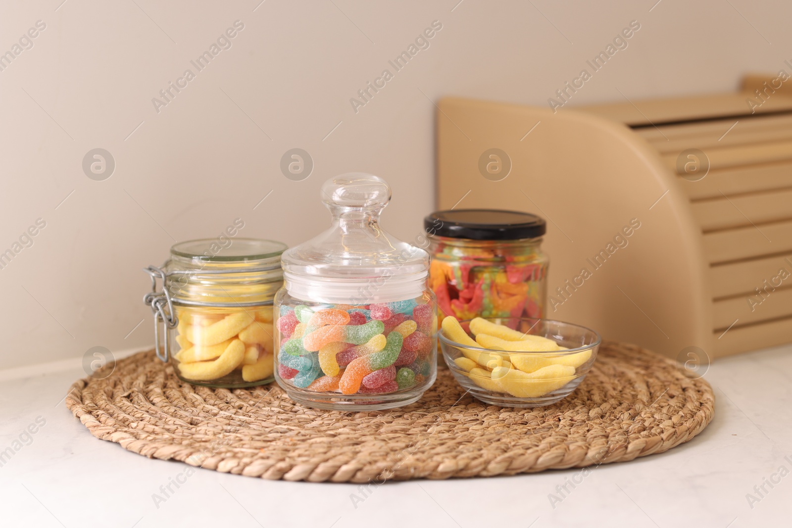 Photo of Tasty gummy candies on white table in kitchen