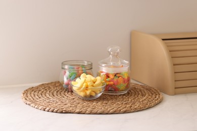 Photo of Tasty gummy candies on white table in kitchen