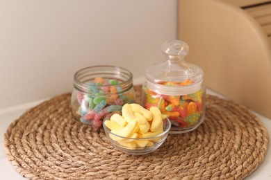 Photo of Tasty gummy candies on table in kitchen