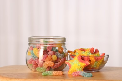 Photo of Tasty gummy candies on wooden table, closeup