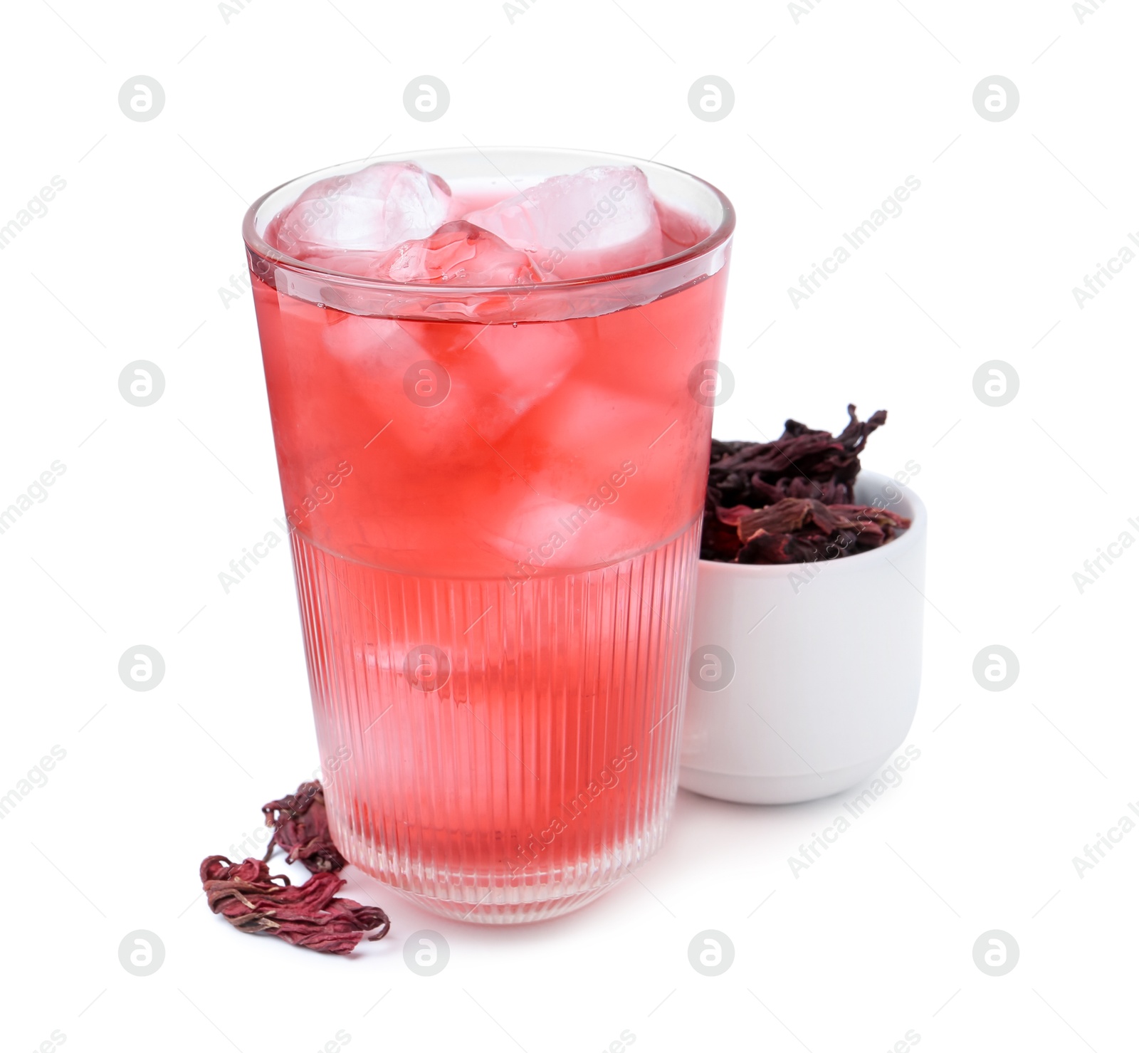 Photo of Delicious hibiscus tea with ice in glass and dry roselle sepals isolated on white