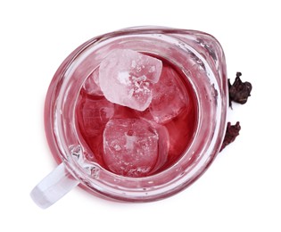 Photo of Delicious hibiscus tea with ice in glass jug and dry roselle sepals isolated on white, top view