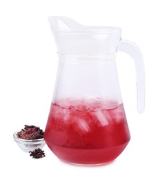 Photo of Delicious hibiscus tea with ice in glass jug and dry roselle sepals isolated on white