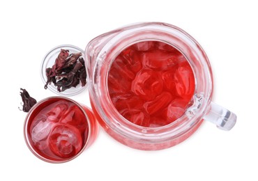 Photo of Delicious hibiscus tea with ice and dry roselle sepals isolated on white, top view